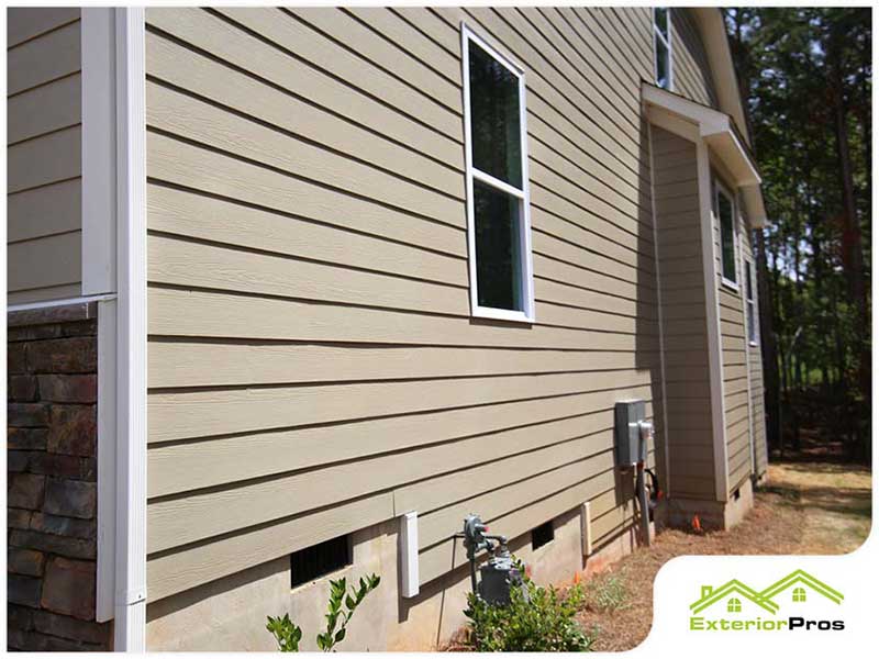 Close up of the side of a home with brown siding